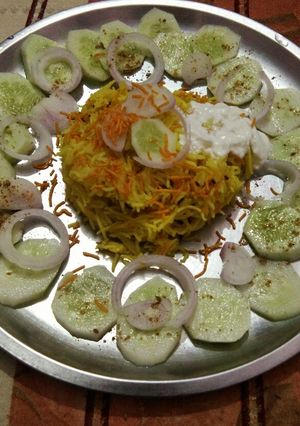 A picture of Chatpate rice with curd aloo bhujia and salad.