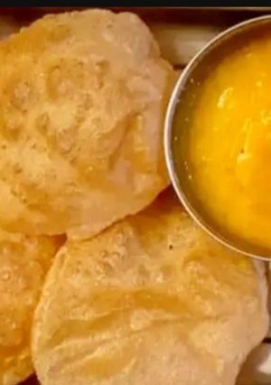 A picture of Aam ras with puri.