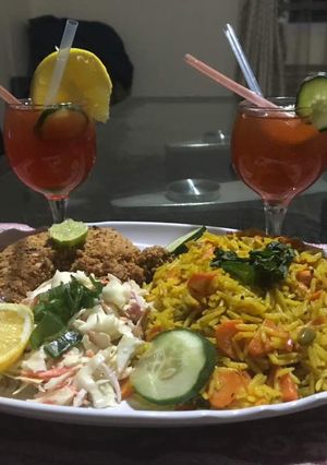 A picture of Basmatic Jollof rice with KFC & salad.