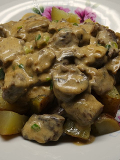 A picture of Beef Stroganoff over Sautéed Potatoes.