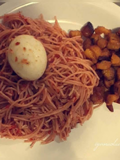 A picture of Spagetti with feied plantain and boiled egg.
