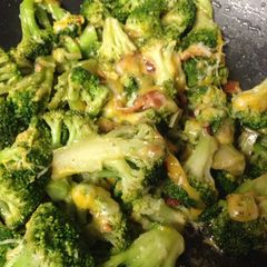 A picture of Bacon and cheese stir fried broccoli.