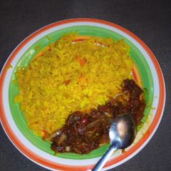 A picture of Yellow rice with sauces.