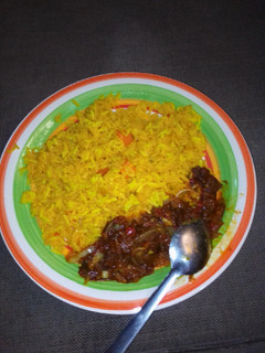 A picture of Yellow rice with sauces.