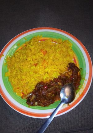 A picture of Yellow rice with sauces.