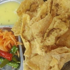 A picture of Fafda kadhi and raw papaya Sambharo.