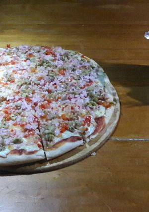 Una foto de Pizza a la casa.