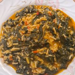 A picture of Spinach with tomato sauce.