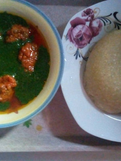 A picture of Stew and ewedu soup.with eba.