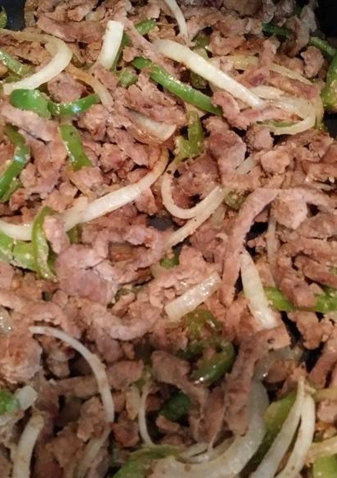 Una foto de Bisteck con pimiento y cebolla