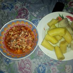 A picture of Boiled yam and plantain with egg sauce.