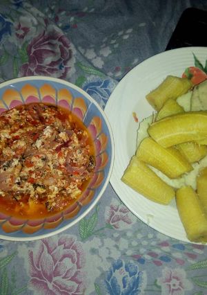 A picture of Boiled yam and plantain with egg sauce.
