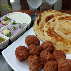 Gola kabab & lachcha Paratha with cold drink A picture of Gola kabab & lachcha Paratha with cold drink.