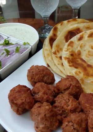 A picture of Gola kabab & lachcha Paratha with cold drink.