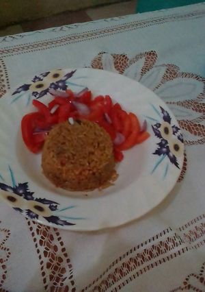A picture of Beef pilau served with kachumbari.