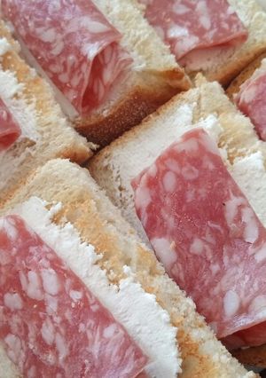 A picture of Bruschette with goat's cheese and salame.