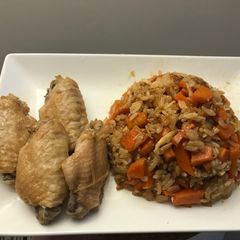 A picture of Rice with carrots and chicken wings.