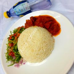 A picture of Rice and stew with salad.