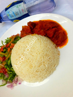 A picture of Rice and stew with salad.