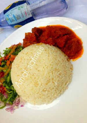 A picture of Rice and stew with salad.