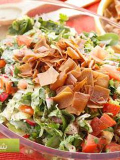 A picture of Bread and vegetables salad with sumac - fattoush.