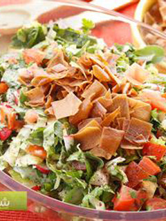 A picture of Bread and vegetables salad with sumac - fattoush.