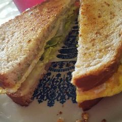 Breakfast egg cheese and avocado sandwich A picture of Breakfast egg cheese and avocado sandwich .