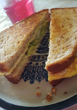 A picture of Breakfast egg cheese and avocado sandwich .