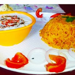 Tomato Rice with boondi Raita A picture of Tomato Rice with boondi Raita.