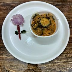 A picture of Kerala style karela masala curry.