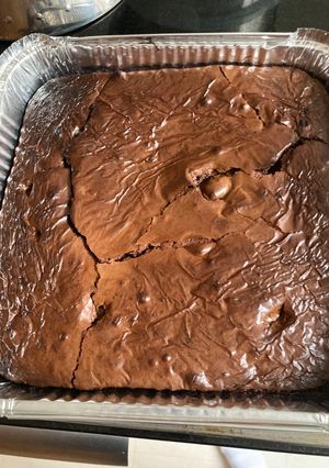A picture of Brownies with chocolate chuncks.