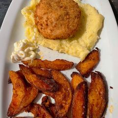 A picture of Garlic&herb Kiev on a bed of buttery mash & side of paprika wedges feed 2 for £3.