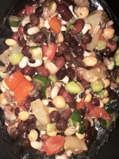 A picture of Veggies and fruits and beans and chickpea salad with lemon.