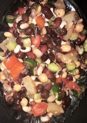 A picture of Veggies and fruits and beans and chickpea salad with lemon.