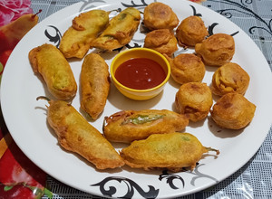 A picture of Batata vada & mirchi vada.