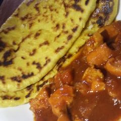 Butter naan with spicy chicken curry A picture of Butter naan with spicy chicken curry.