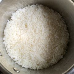 A picture of Cooking Rice in a Pot.