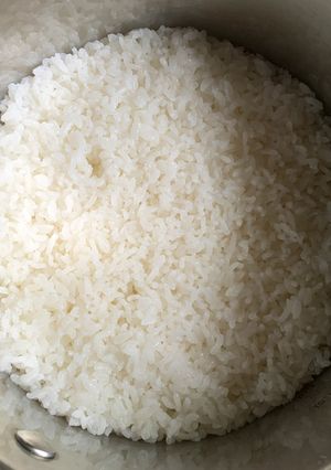 A picture of Cooking Rice in a Pot.