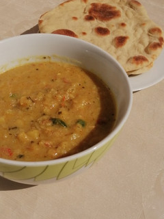 A picture of Naan bread with potato soup.