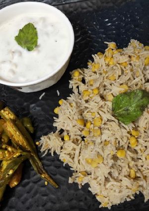 A picture of Chana Dal khichdi with boondi ratia and aloo bhindi.