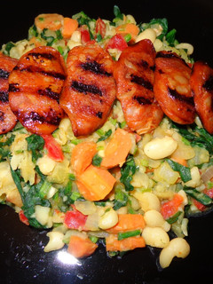 A picture of Braised white beans with spinach and grilled chorizo.