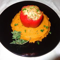 A picture of Red bell peppers stuffed with oregano chicken on sweet potatoes puree.
