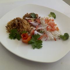 A picture of Chicken Pilau, minced meat with Vegetable rice.