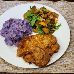 A picture of Chipotle Pork Chops w/ Garlic Purple Potatoes and Veggie Medley.