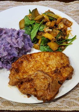 A picture of Chipotle Pork Chops w/ Garlic Purple Potatoes and Veggie Medley.