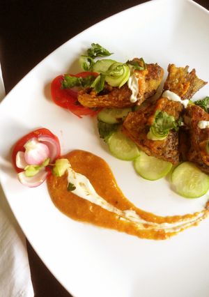 A picture of Ilish fish fry with spicy cream coconut sauce.