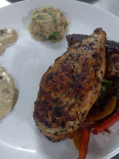 A picture of Stuffed chicken with cream mushroom sauce.