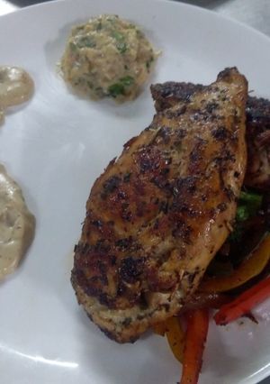 A picture of Stuffed chicken with cream mushroom sauce.