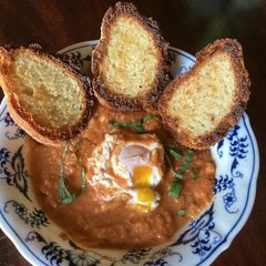 A picture of California Farm Shakshouka Poached Egg Dish in Gazpacho Sauce.