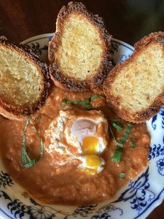 A picture of California Farm Shakshouka Poached Egg Dish in Gazpacho Sauce.